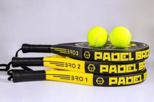 Vibrant padel rackets and tennis balls on white backdrop, ideal for sports themes. For padel rackets page
