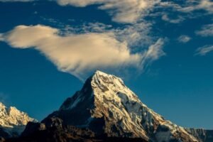 Stunning snow-capped mountain peak under a vibrant sky, perfect for nature lovers. For action sports equipment page