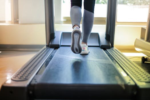 Close-up shot of a person exercising on a treadmill, showcasing fitness and health focus. For best folding treadmills for home.