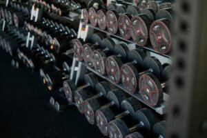 A neatly arranged set of dumbbells on a rack in a modern gym, ideal for fitness enthusiasts. for dumbbells sets page