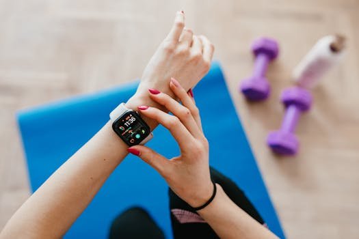 A woman checks fitness data on her smartwatch during a workout at home. Football GPS tracker page