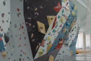 Vibrant indoor climbing wall with colorful holds, perfect for sport enthusiasts seeking adventure. Climbing boards
